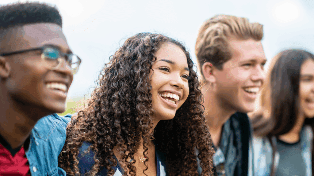 teenagers smiling together looking off into the distance