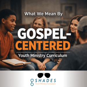 Diverse group of teenagers sitting in a circle during youth group with large overlay text reading "what we mean by gospel-centered youth ministry curriculum" with a G Shades logo at the bottom