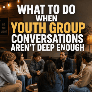Youth pastor leading a small group discussion with diverse teenagers in a warm youth ministry space, with the title “What to Do When Youth Group Conversations Aren’t Deep Enough.”