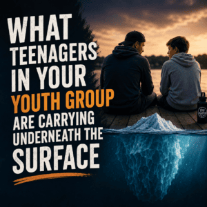 Youth leader talking with a teenager near an iceberg, representing what students carry beneath the surface.
